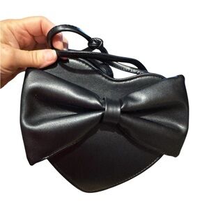 Black heart shaped Crossbody with a bow on front ;excellent condition.